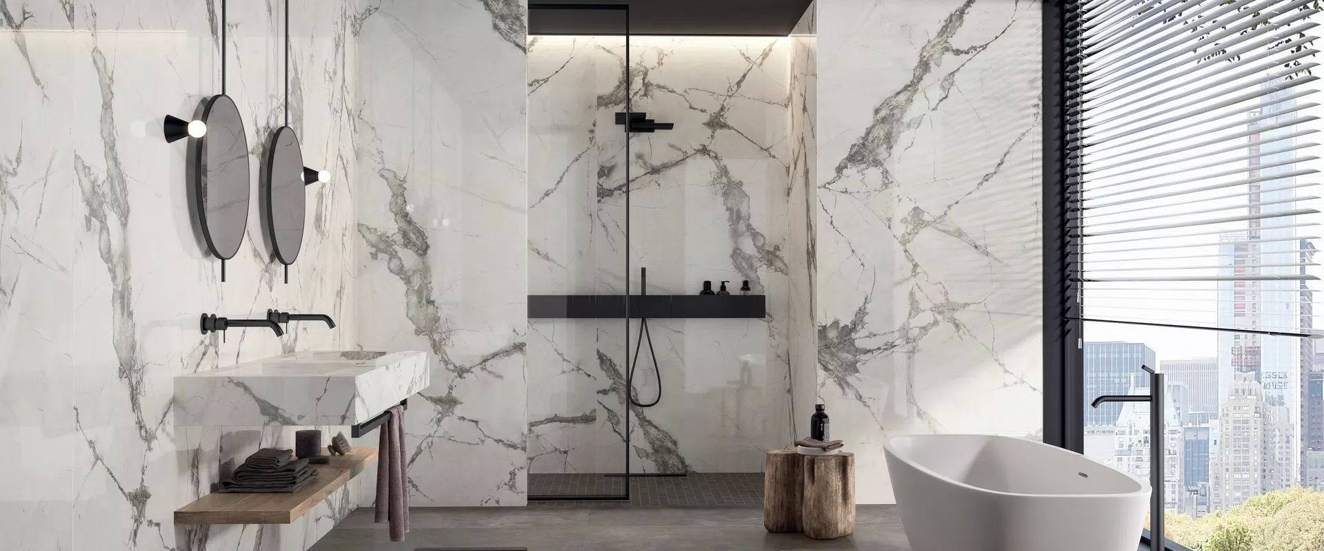 Supreme Evo collection by Flaviker: marble-effect tiles in white, black, grey tones.
